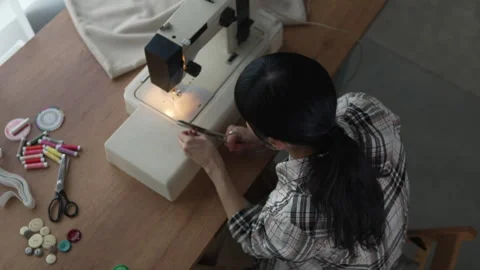 Seamstress using a sewing machine at home Stock Footage 326005384