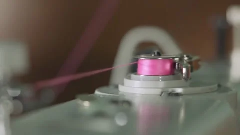 The seamstress winds the thread around the bobbin. Video stock 144108922