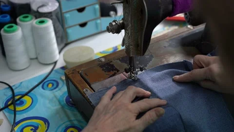 Seamstress work from behind the shoulder, home production, tailor works Stock Footage 223383059