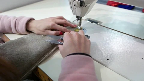 Seamstress working behind the sewing machine Stock Footage 87998137