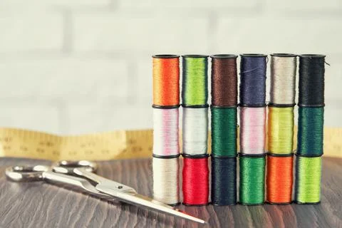 Seamstress working place with threads, scissors and measuring tape Stock Photos
