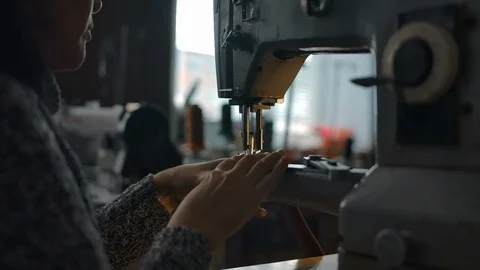 Seamstress working on sewing machine, stitching textile. Atelier, repairing and Video stock 122783320