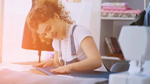 The seamstress working with a textile on the table Vídeo Stock 107653700