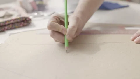 Seamstress writing notes on sewing pattern, making clothes in fashion studio Video stock 153985429