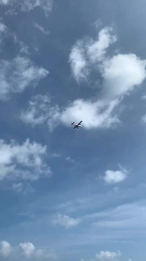 Seaplane flying in blue sky over tropical resort Maldives 9:16 Stock Footage 344699652