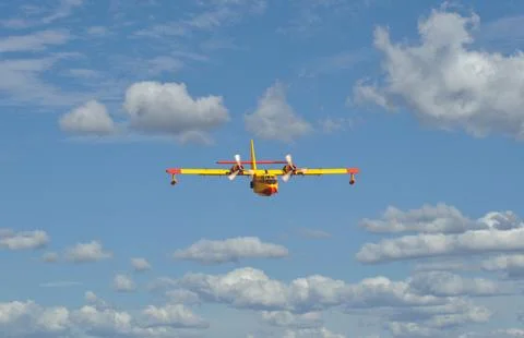 Seaplane in full flight in the sky with clouds, fighting fires Stock Photos