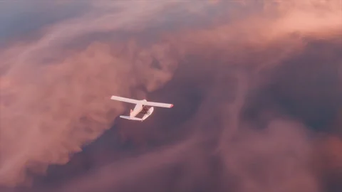 Seaplane plane gliding over sunset clouds showcasing vibrant colors Stock Footage 322543604
