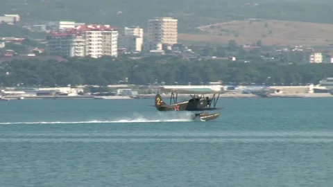 Seaplane U-2 or Po-2 (NATO: "Mule") accelerates through water and takes off. Stock Footage 131583665