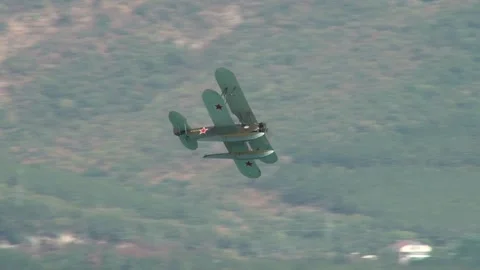 Seaplane U-2 or Po-2 (NATO: "Mule"). Seaplane performs aerobatics over bay. Stock Footage 131583686