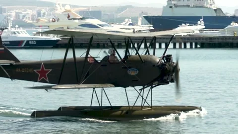 Seaplane U-2 or Po-2 (NATO: "Mule") floats like boat toward shore. Stock Footage 131583687