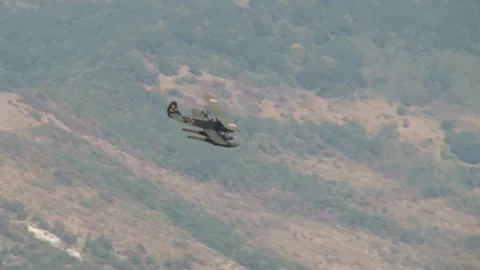 Seaplane U-2 or Po-2 (NATO: "Mule"). Seaplane performs aerobatics over bay. Stock Footage 131583704