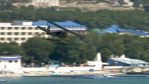 Seaplane U-2 / Po-2 (NATO: "Mule") performs aerobatics over Gelendzhik Bay. Stock Footage 121497455