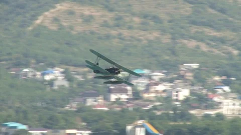 Seaplane U-2 / Po-2 (NATO: "Mule") performs aerobatics over Gelendzhik Bay. Stock Footage 123635235