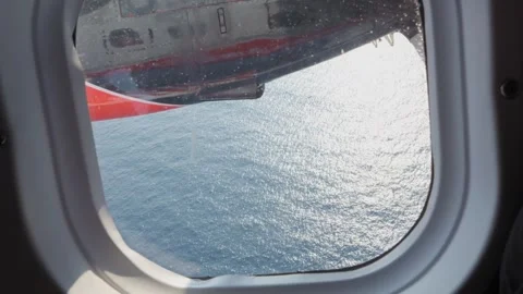 Seaplane Window View Over Sunlit Indian Ocean Waters in the Maldives Stock Footage 344060525