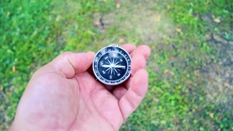 Search for the cardinal points with a compass. Compass in hand.  Stock Footage 204118730