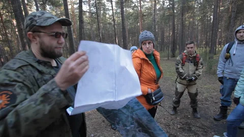 The search coordinator holds paper maps of the area Video stock 166663782