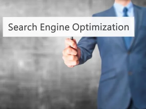 Search Engine Optimization - Business man showing sign Stock Photos