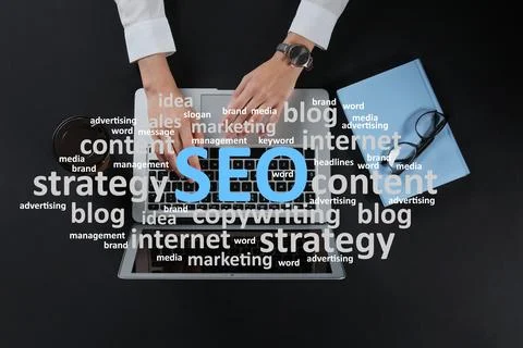 Search engine optimization (SEO). Cloud of words above copywriter with lapt.. Stock Photos