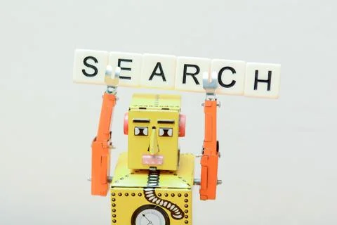Search engine robot is looking for the best online website metaphor with toy  Stock Photos