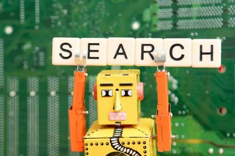 Search engine robot is looking for the best online website metaphor with toy  Stock Photos