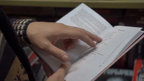 Search for information in the book on the table of contents. Man's hands 動画素材 101721185
