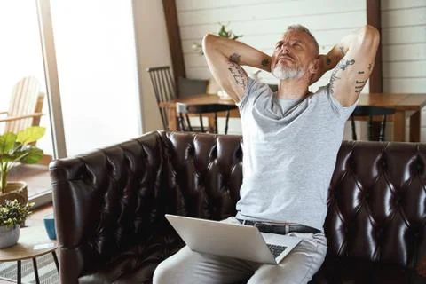 In search of inspiration. Thoughtful mature man in casual clothes looking upside Stock Photos