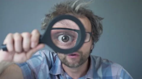 Search looking for concept. crazy scientist surprised  man. a magnifying glass Stock Footage 135775525