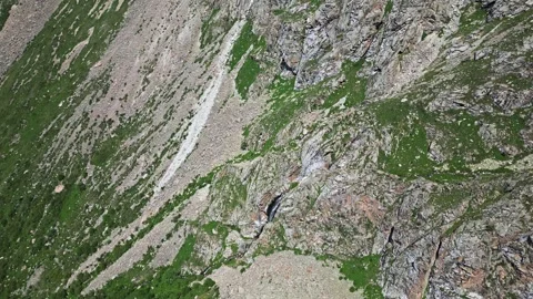 Search for missing people in mountains using a drone. extreme mountain terrain Stock Footage 300751267