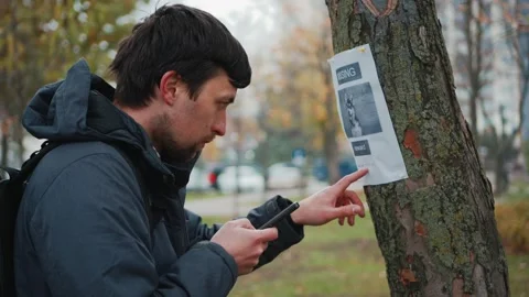 Search for missing pets. Lost dog man found her and calls the owner on an Stock Footage 319022891