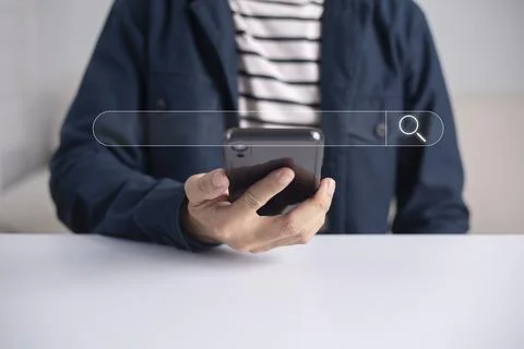 Search technology, search engine optimization, man's hand using smartphone to Stock Photos