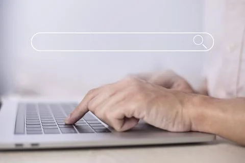 Search technology, search engine optimization, man's hand using laptop to sea Stock Photos