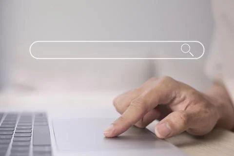 Search technology, search engine optimization, man's hand using laptop to sea Stock Photos