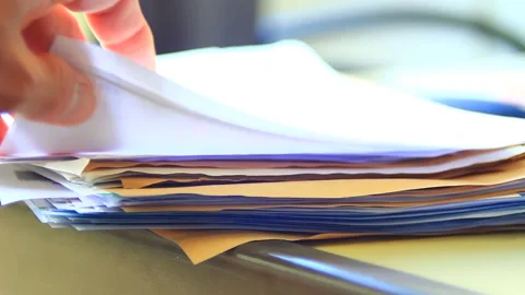 Searching among stack of documents on the table Stock Footage 164537649