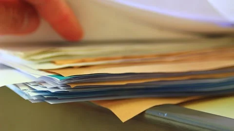 Searching among stack of documents on the table Stock Footage 164537787