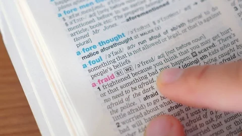 Searching for and finding a word afraid definition in a dictionary Stock Footage 97924071