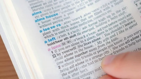 Searching for and finding a word alone definition in a dictionary 動画素材 97923626