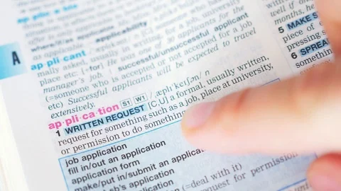 Searching for and finding a word application definition in a dictionary Stock Footage 97923483