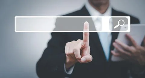 Searching Browsing Internet Data Information with blank search bar. man's han Stock Photos