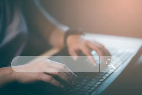 Searching Browsing Internet Data Information with blank search bar. man's han Stock Photos