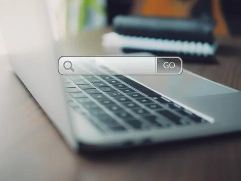 Searching Browsing Internet with smart phone and laptop computer  in office.  Stock Photos