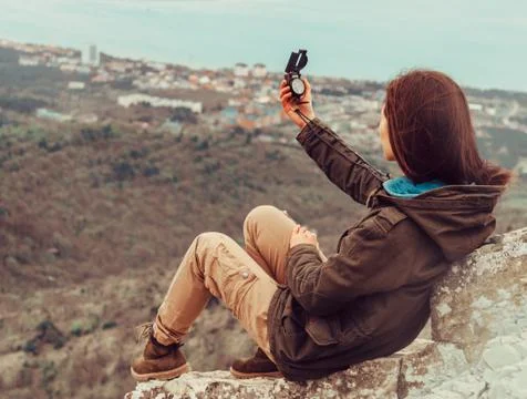 Searching direction with a compass Stock Photos