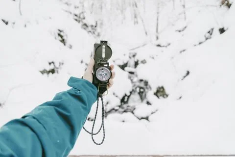 Searching direction with compass in winter Foto stock