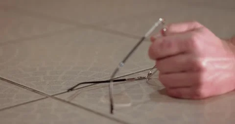 Searching for dropped broken glasses Stock Footage 248721651
