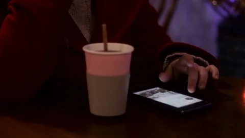 Searching internet smart phone while drinking coffee tea at night Stock Footage 71585341