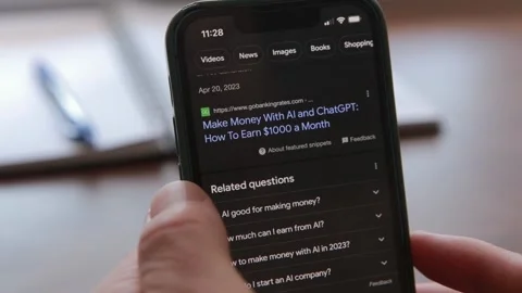 Searching on iPhone for ways to Make Money in 2023 using Chat GPT Stock Footage 240576687