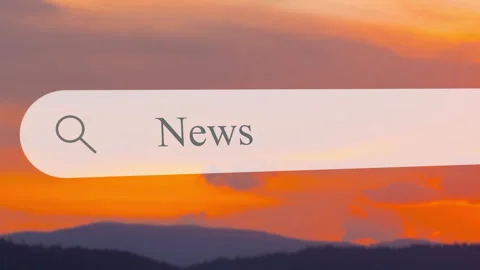 Searching for news in a digital format during sunset at a lakeside location Stock Footage 330420641