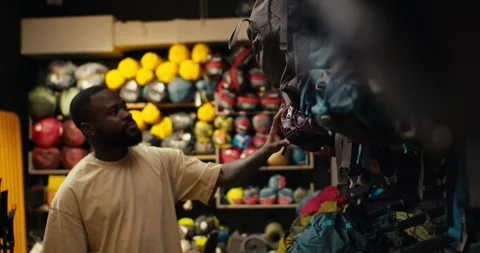 Searching for the Perfect Backpack in a Specialized Outdoor Gear Store Stock Footage 243454748