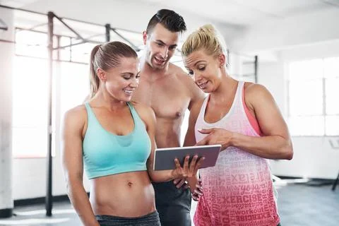 Searching for tutorials for their next session. a group of young people using a Stock Photos