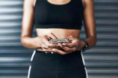 Searching the web for some workout tutorials. Closeup shot of a sporty woman Stock Photos