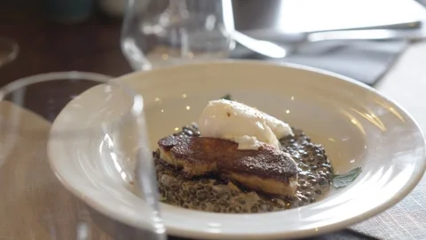 Seared Meat and Poached Egg Served on Lentils in Fine Dining Restaurant Close Up Stock Footage 334833106
